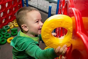Toddler playing with toys and smiling