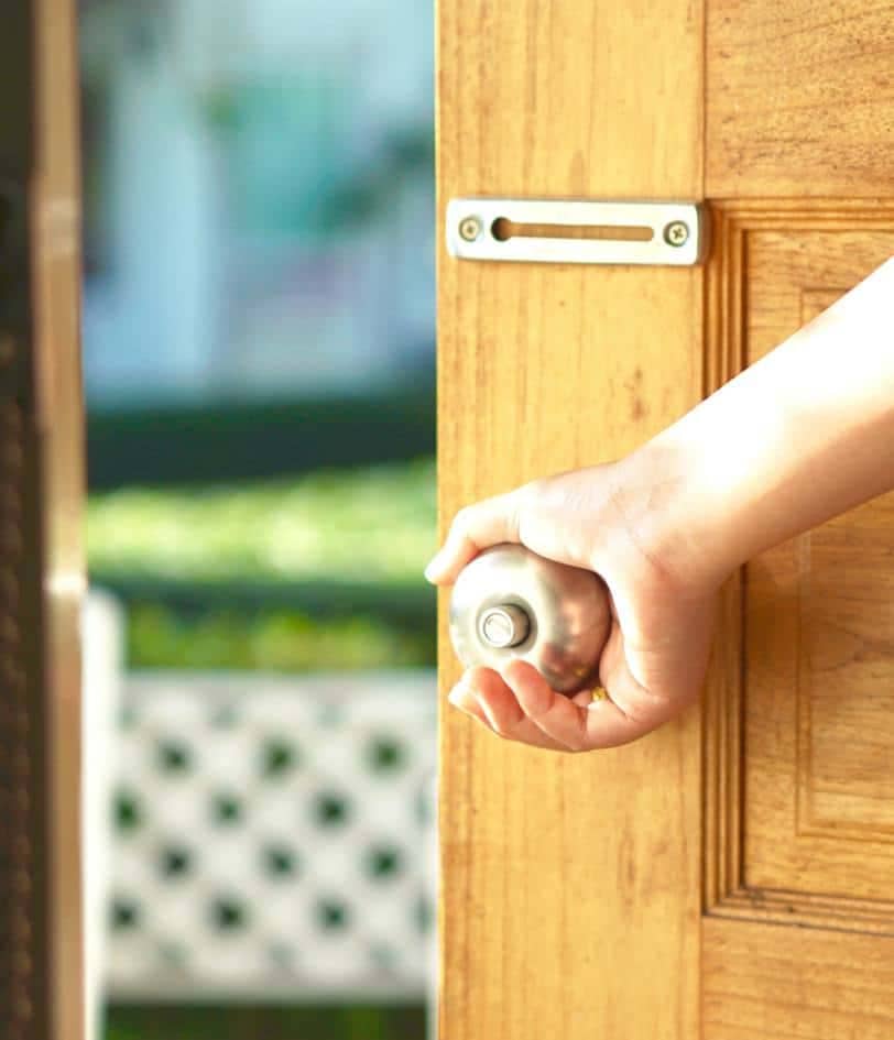 Hand holding the handle of a security door
