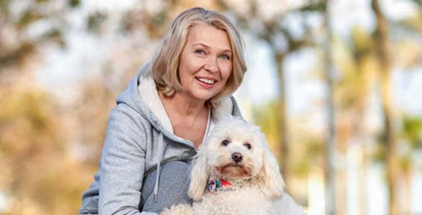 Smiling women with her pet dog