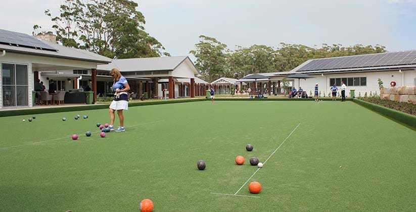 People playing bowls on a well maintain bowls green