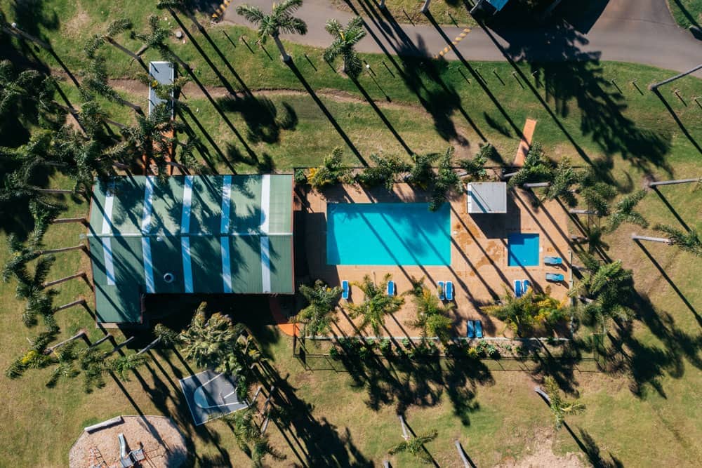 Aerial view of the swimming area and community hall at Milton Valley Holiday Park.