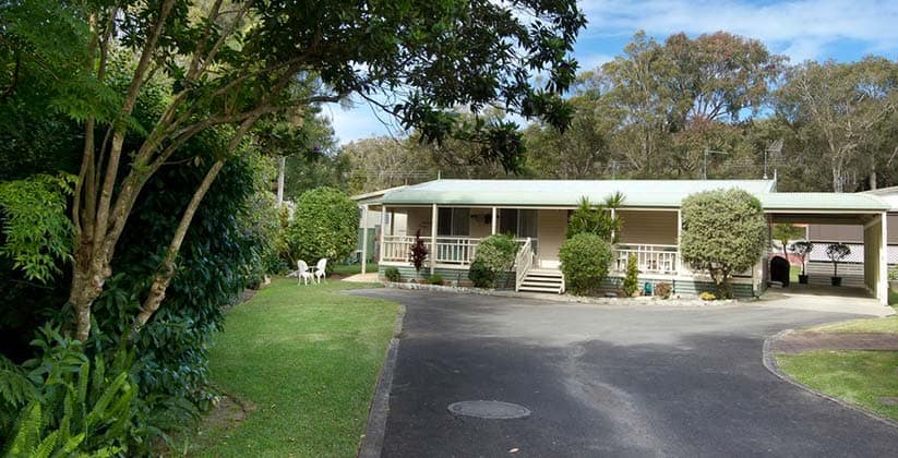 Well maintained gardens and house at Taskers by Hometown Australia